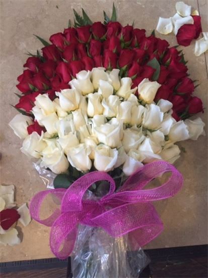 Bouquet of red and white roses tied with a pink ribbon