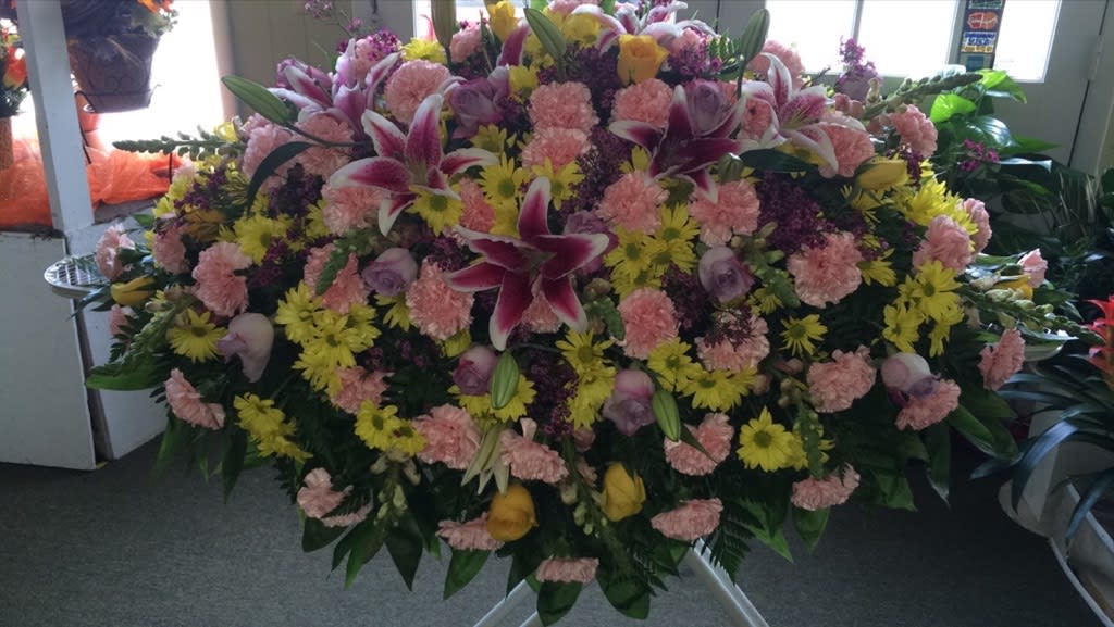 funeral blanket - yellow roses yellow carnations pink lilies and greenery 