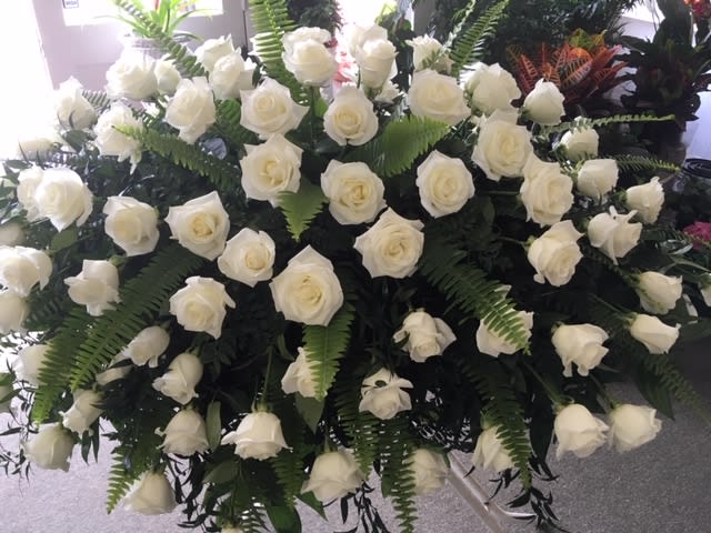 Large arrangement of white roses with fern foliage