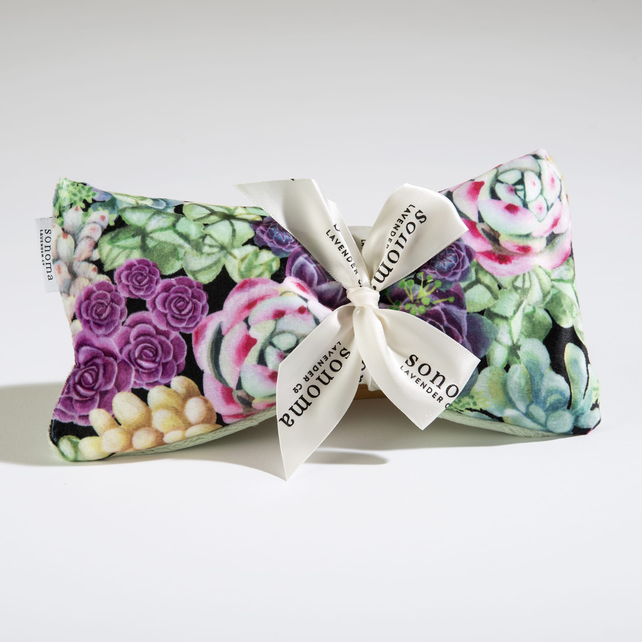 Small rectangular pillow with colorful succulent print and cream bow