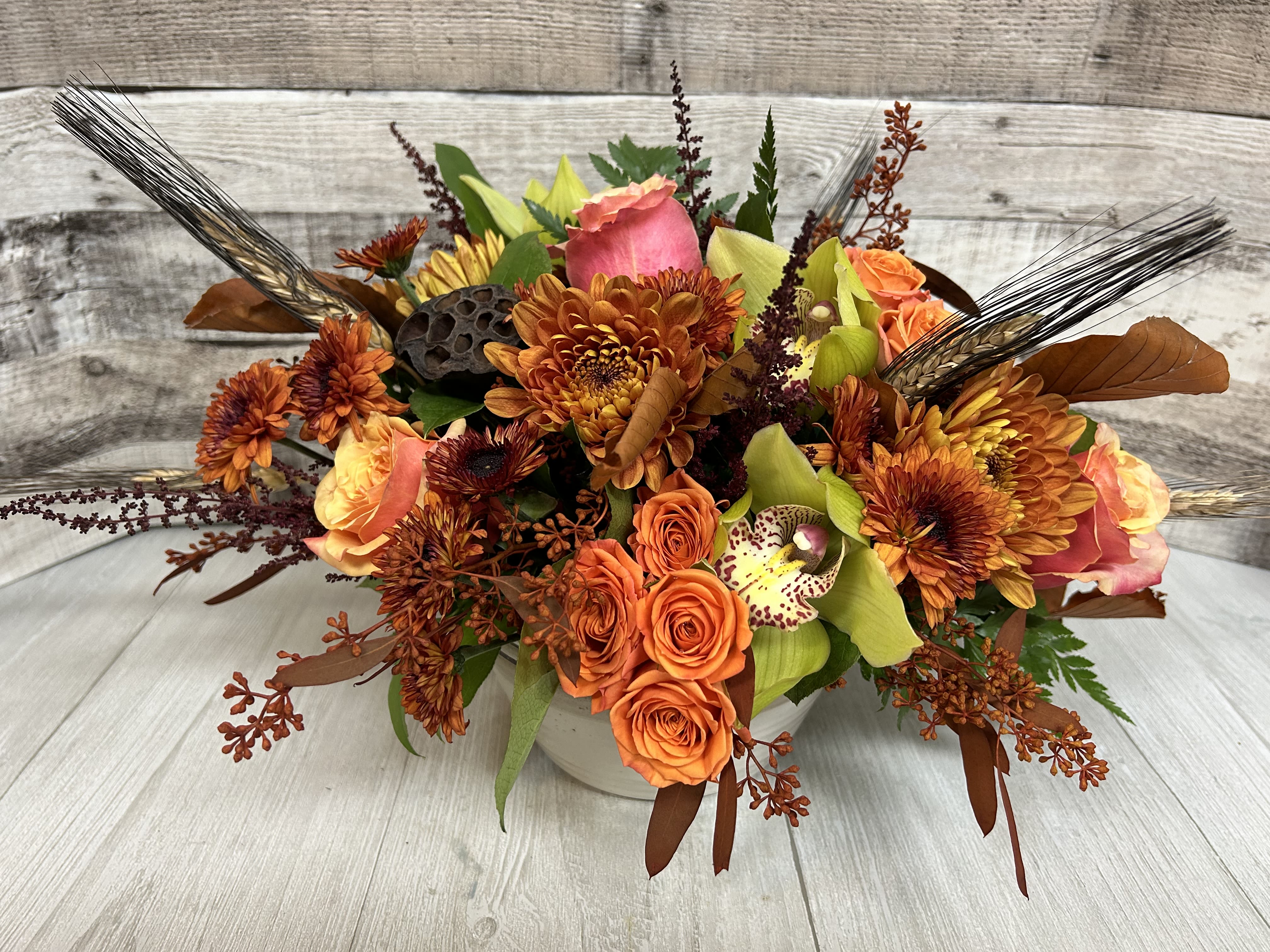 Graceful Gathering - The holidays are a time to gather around and enjoy each others presence. This beautiful centpereice will not only give our loved ones somethign to talk about but also something out tanding to gaze at with cymbidium orchids, roses and more. 