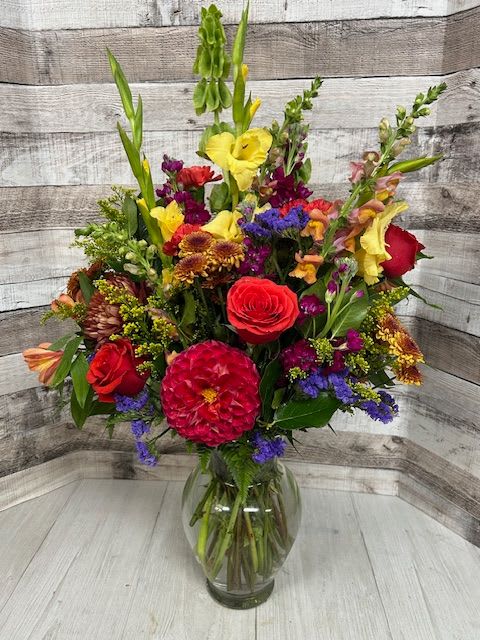 Fall's Finest  - Cozy and inviting, Fall’s Finest captures the warmth of autumn with orange roses, rust-toned mums, and rich burgundy blooms. Textured greenery and vibrant accents complete this seasonal favorite — perfect for bringing the comfort of fall indoors.