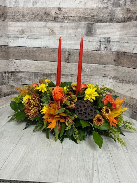 Gather 'Round - "Gather Round" is a warm and inviting floral arrangement designed to bring people together. Bursting with seasonal blooms in rich, comforting tones, this arrangement creates a cozy, celebratory atmosphere—perfect for welcoming friends and family or marking any special occasion with heartfelt charm.