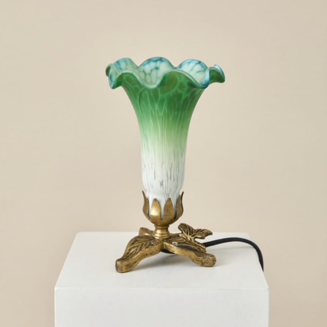 Green and blue glass vase lamp on a white pedestal
