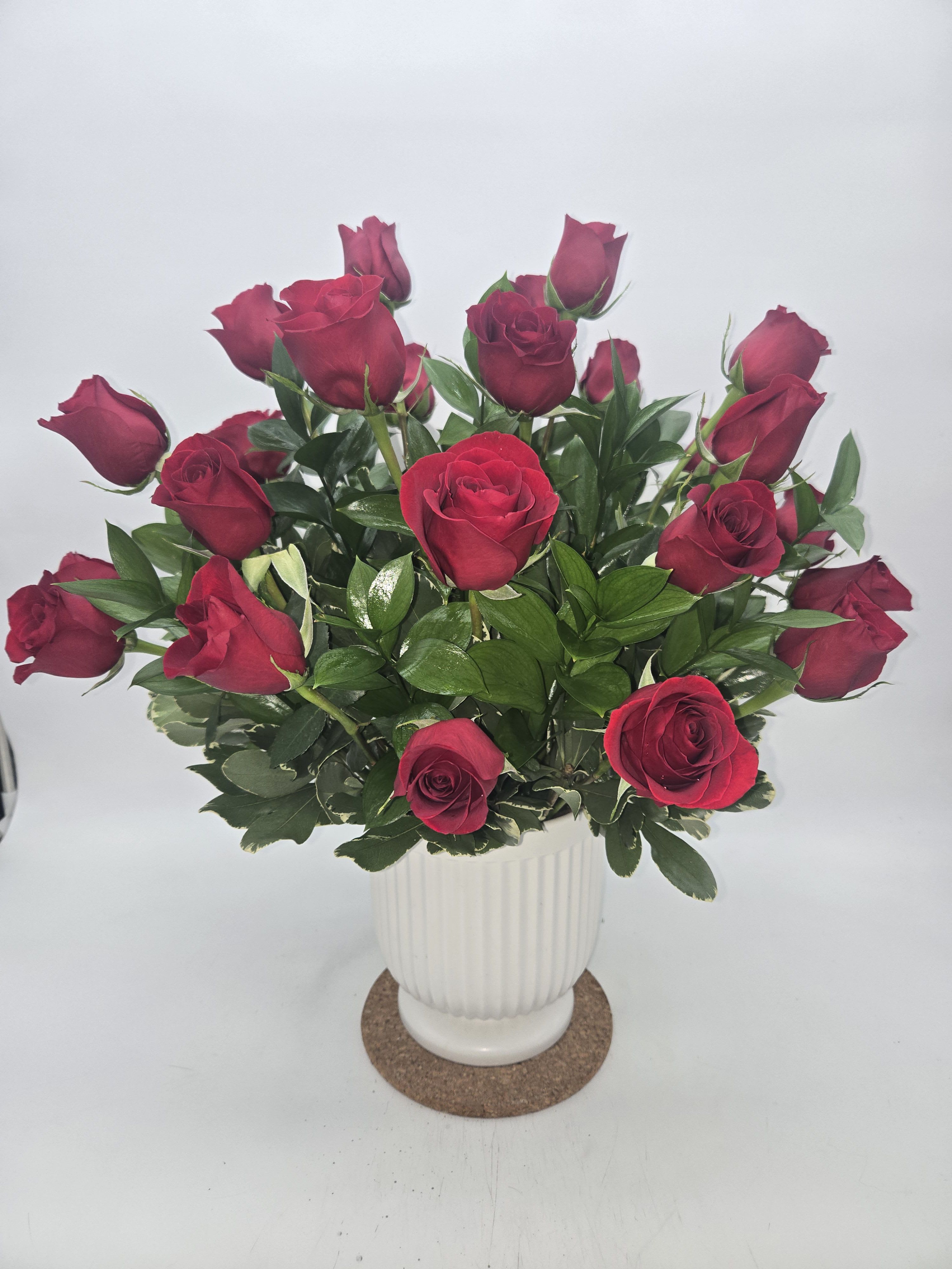 Bouquet of red roses in a white vase