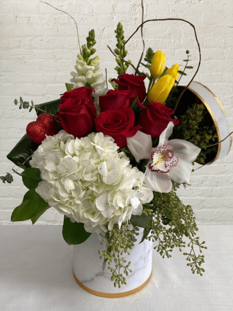 Forget Me Not - Regular 0071 - Forget Me Not is a stunning arrangement by our expert florists, true to life, and designed to add elegance to any room or office. The fresh flowers and delicate greens are delivered in a contemporary vase, a stylish finishing touch that's perfect for any occasion. Includes 6 abundant roses in a magnificent mixed bouquet with unique seasonal blooms express the designer's signature style. Forget Me Not is a timeless gift for any occasion.