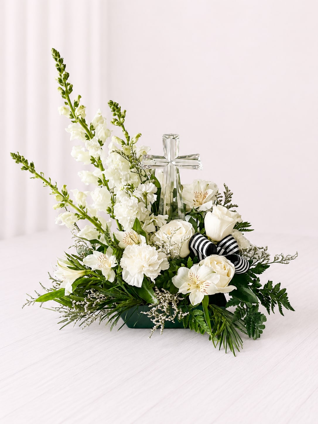 Crystal Cross - This arrangement is all white flowers with a crystal cross in the middle. Makes a nice sympathy keepsake. Arrangement is also available in your choice of flower color, please note color in special instructions.  Small Cross: 8.5 inches x 4.5 inches  