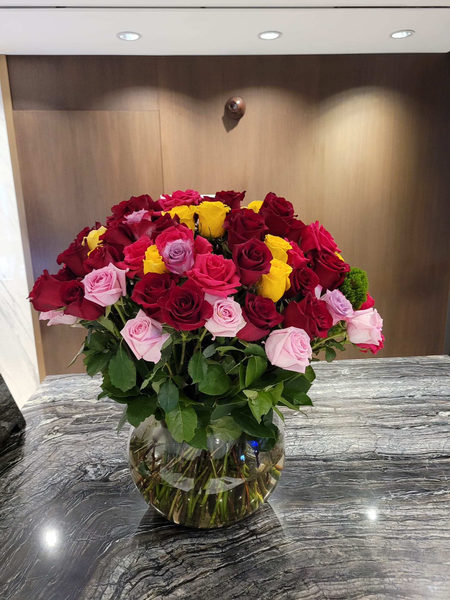 100 Multicolor Reasons to Love You  - This is a beautiful arrangement in a clear glass vase with a lush display of 100 premium long-stem multicolor roses and greenery.  Approximately 27" H by 22" W.