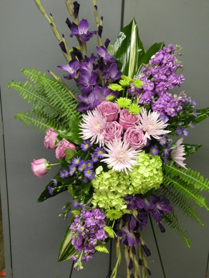 Purple and pink floral arrangement with roses, hydrangea, and tall blooms