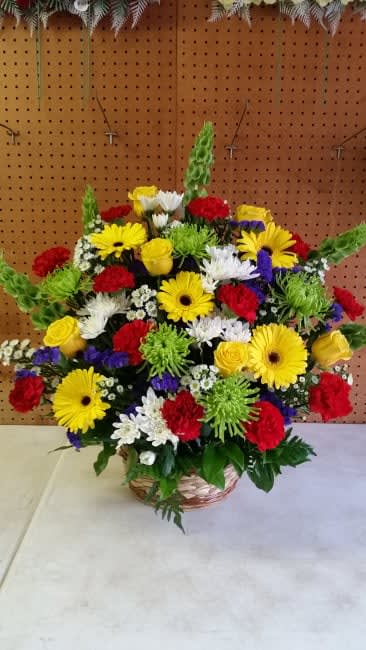 Bright Funeral Arrangment in Wicker - Yellow Roses, Gerbera Daisy, Red Carnation, White Mums, Green Fuji, Aster