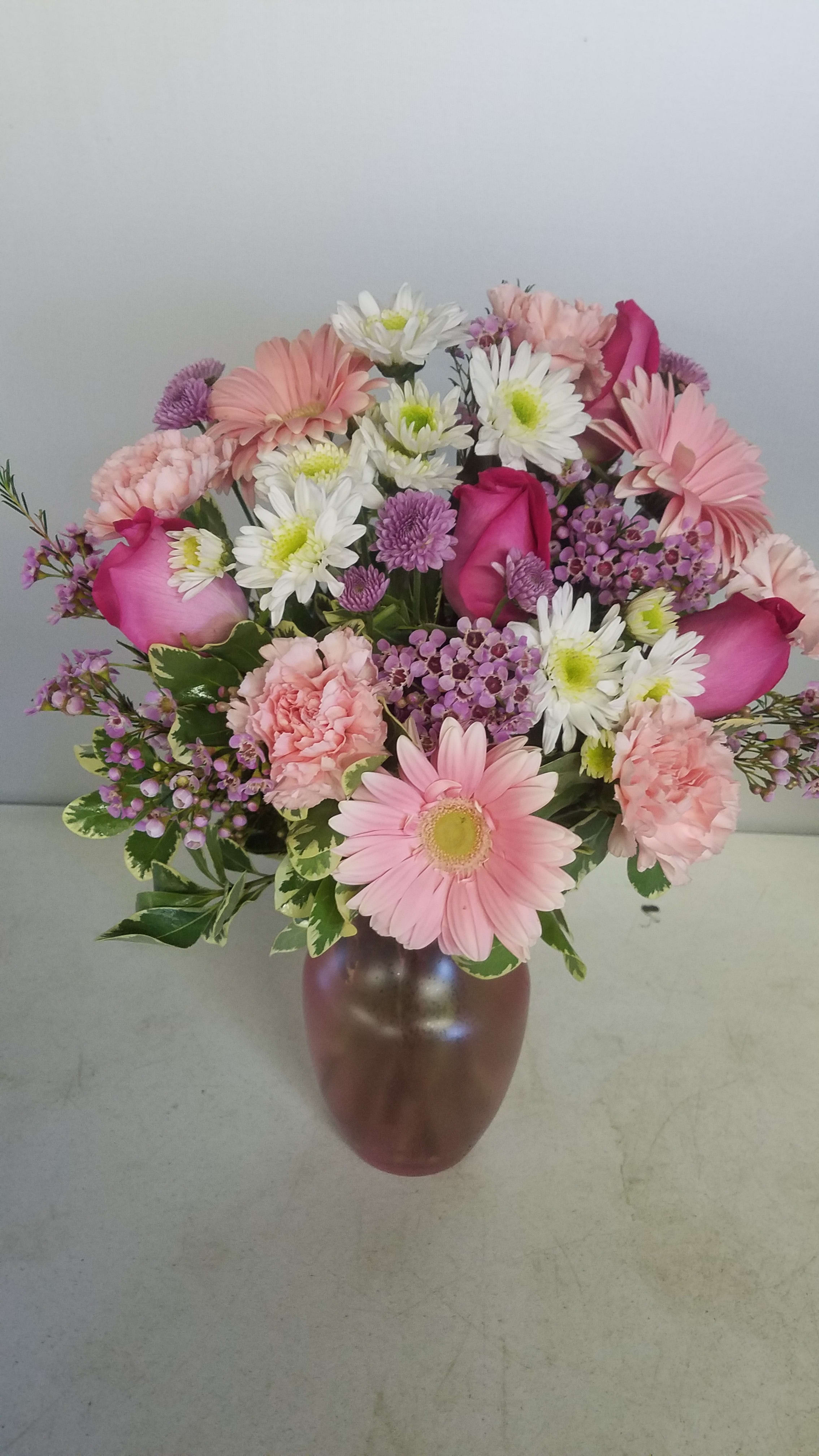 Pink and white mixed bouquet in a brown vase