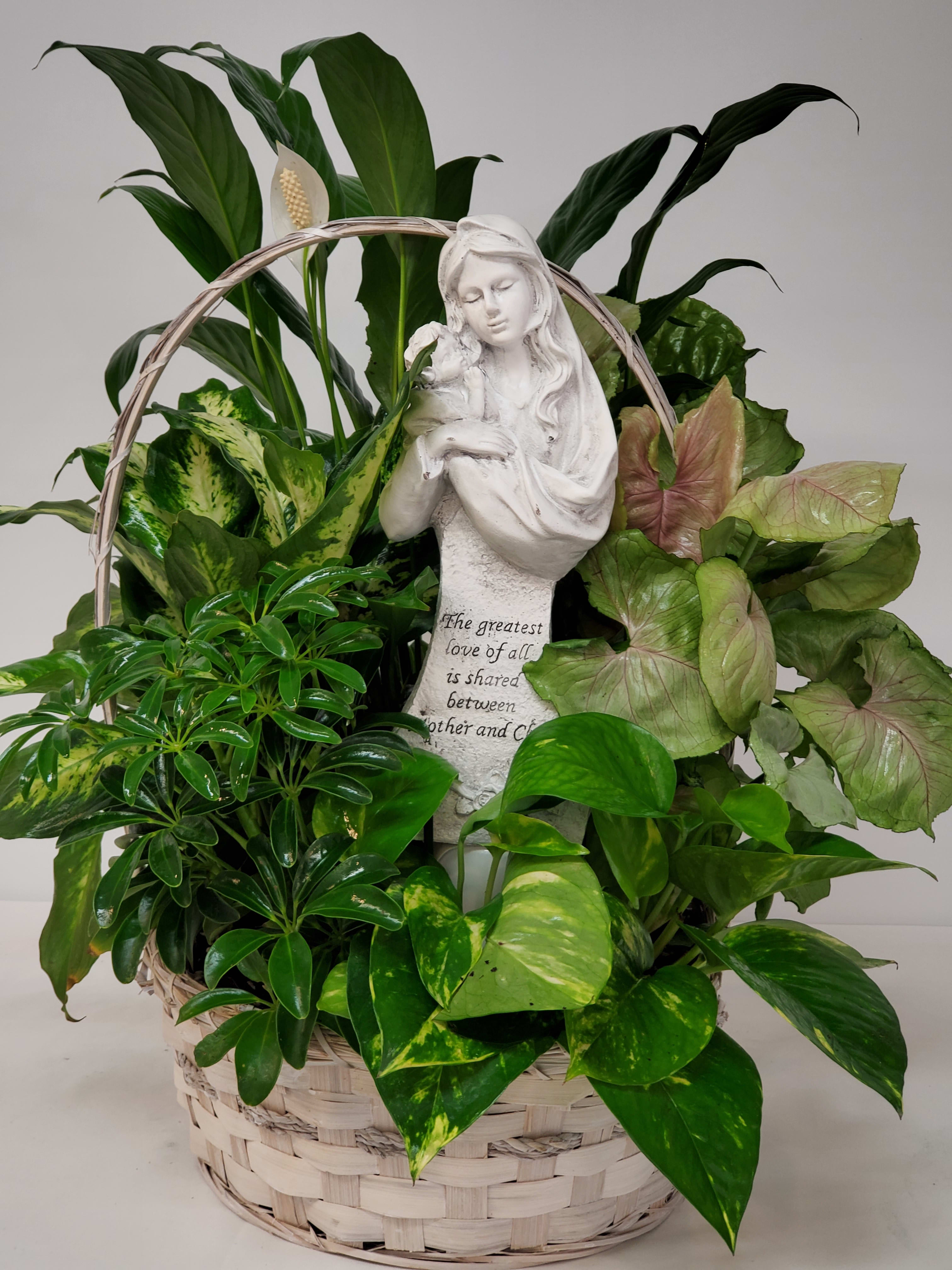 Basket of green houseplants with a white angel statue centerpiece