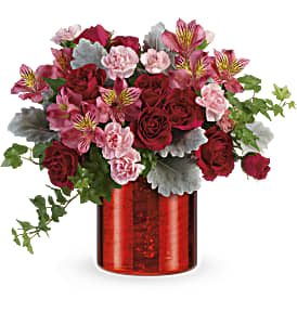 Bouquet of red roses and pink alstroemeria in a red vase