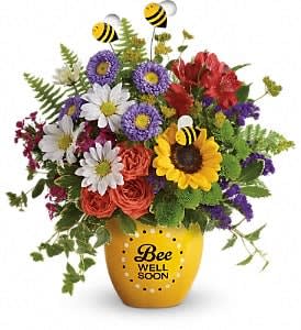 Colorful bouquet in a yellow vase with bee decorations and a "Bee Well Soon" message