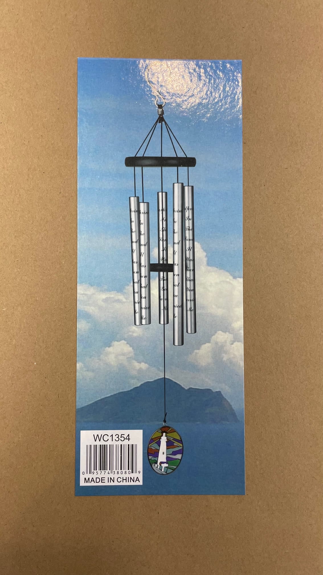 Silver wind chime hanging on a blue sky-themed card