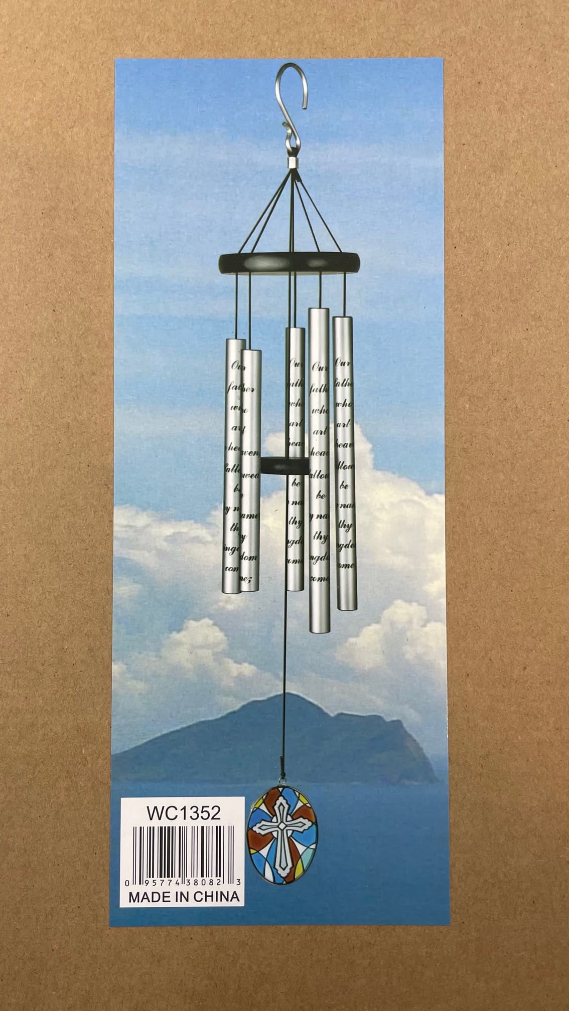 Silver wind chime with a cross pendant on a printed card
