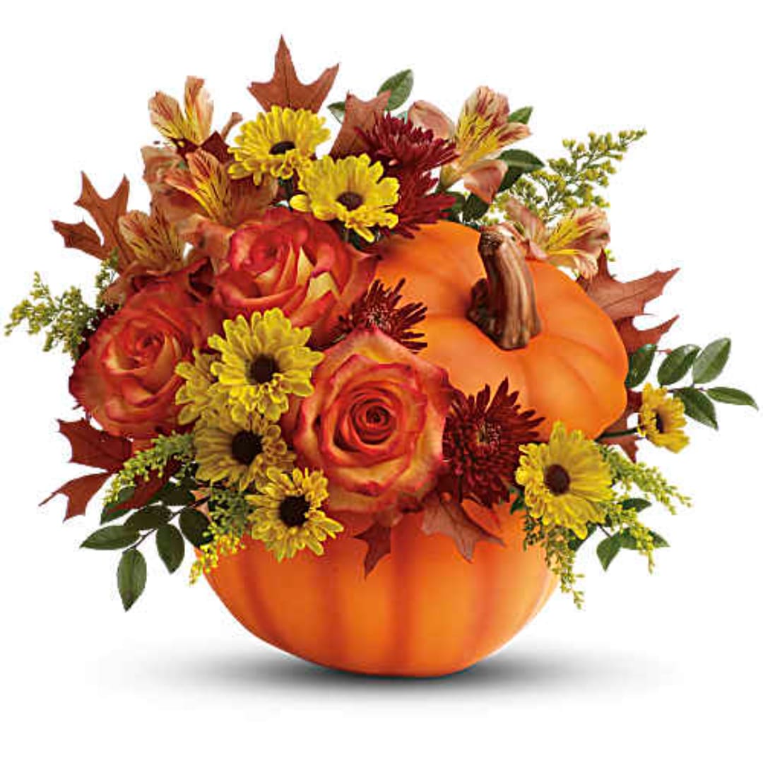 Fall bouquet in a pumpkin container with roses and yellow daisies