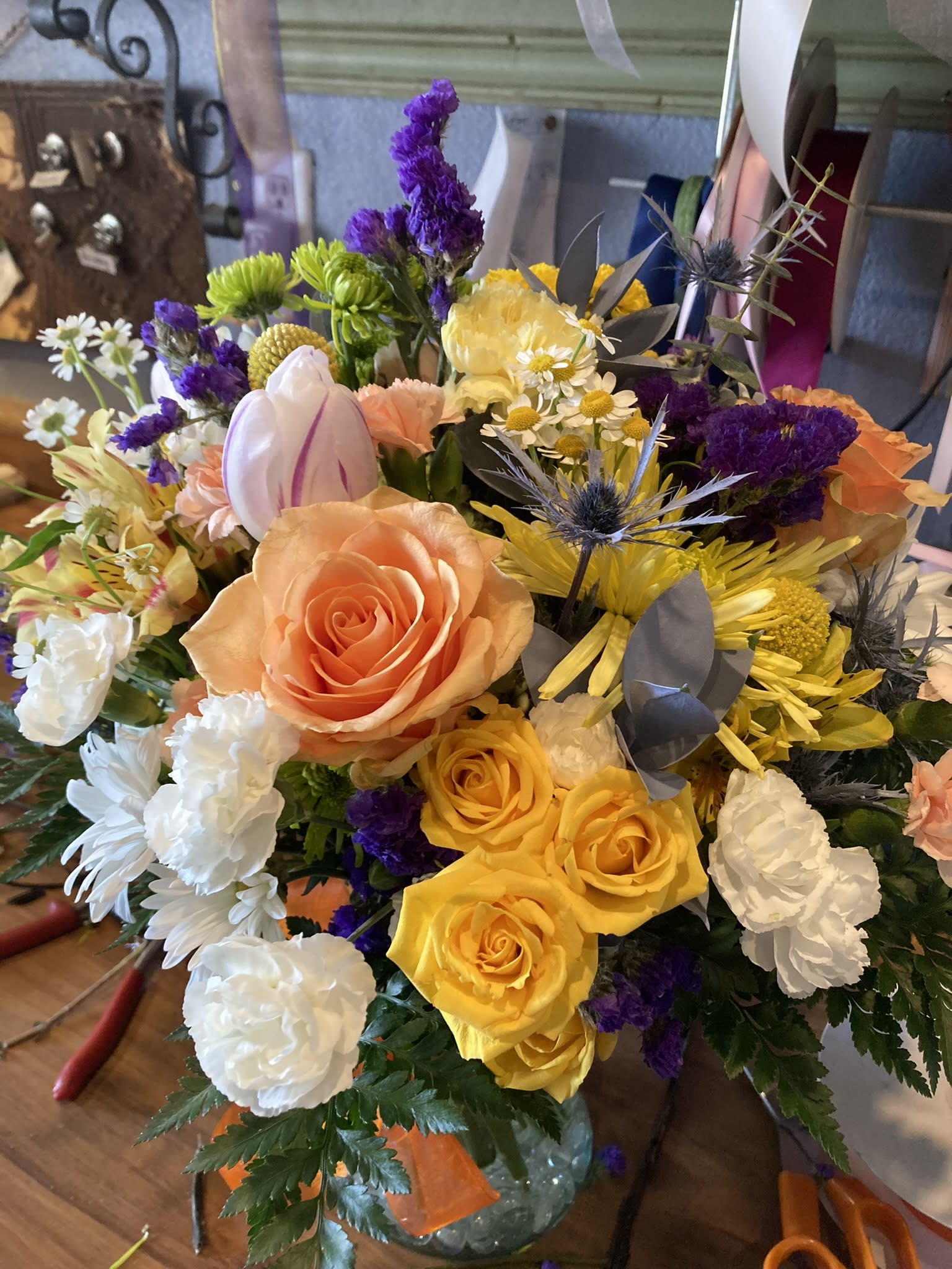 Peach/Orange Glow - What’s pretty in peach? This rich mix of peach and yellow roses and lovely blossoms, simply arranged in a clear glass vase, will create a warm glow in any setting. A charming bouquet for anyone who loves flowers. Or, pick your favorite color and we can design a similar style arrangement in your color of choice. 