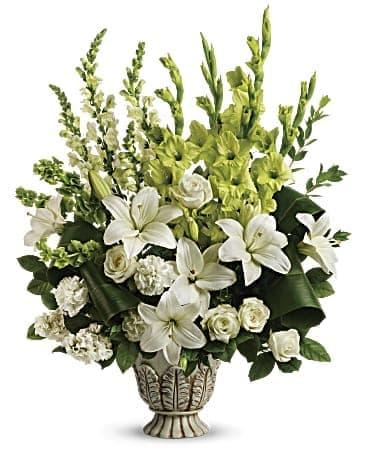 White lilies and roses in a decorative vase with green flowers