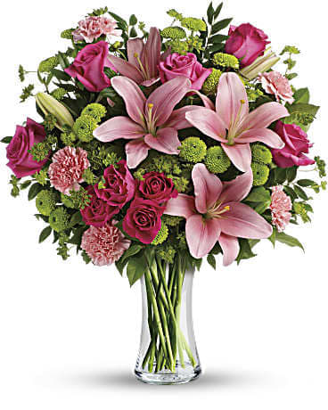 Pink lilies and roses in a clear glass vase