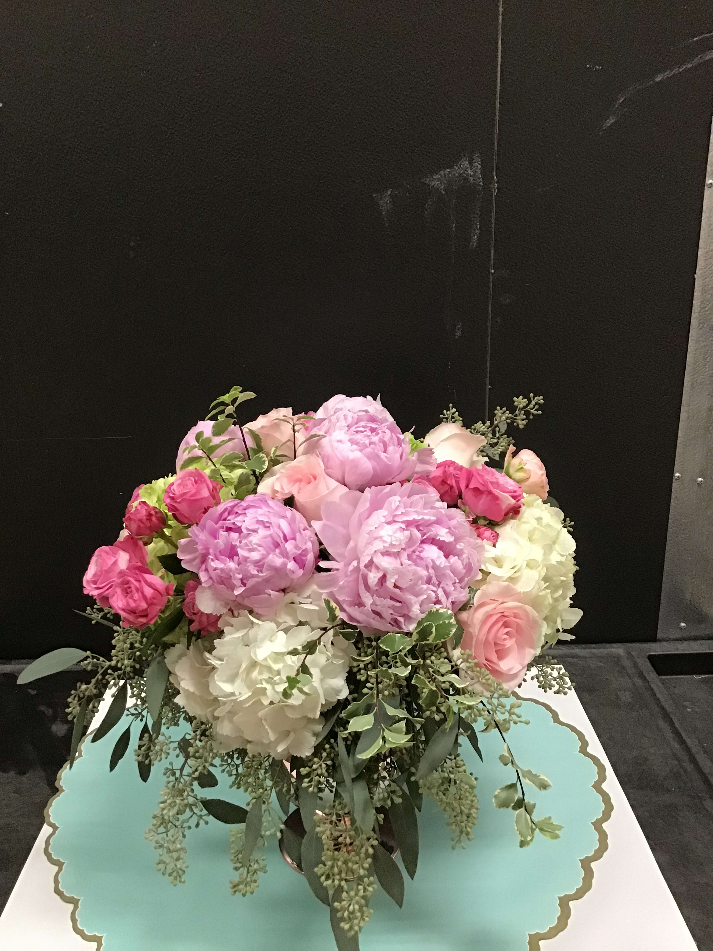 Pink and white floral arrangement in a vase