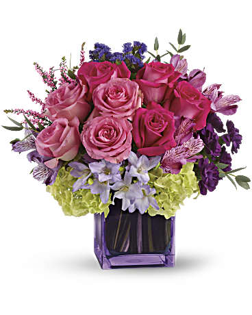 Exquisite Beauty - This exquisite mix of feminine blooms is like a breath of fresh air! Sweet pinks and purples are contrasted with a modern burst of fresh green hydrangea, and finished off with a pretty lavender cube vase lined with a tropical aspidistra leaf.