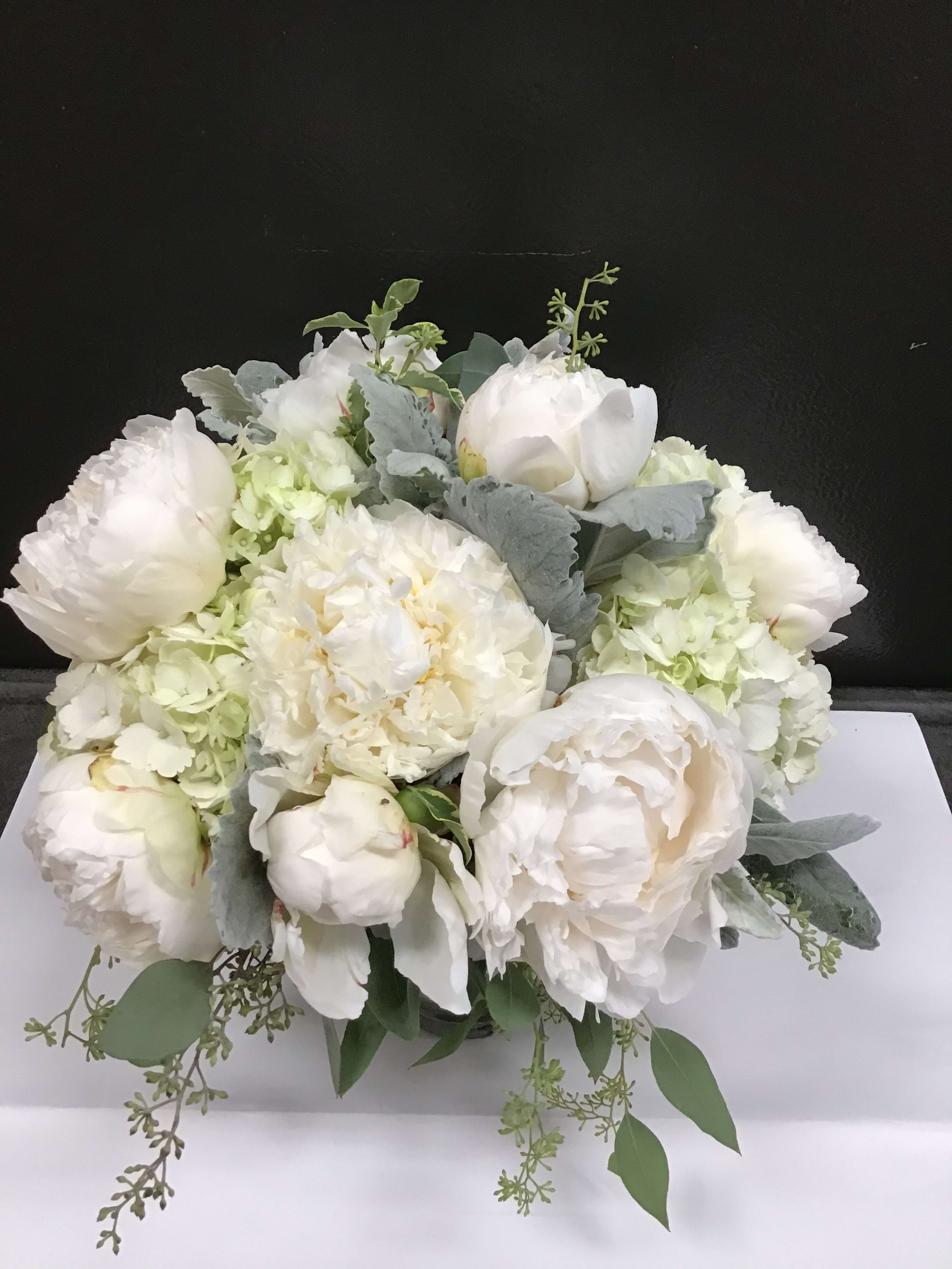 White peonies and hydrangeas arranged in a low bouquet