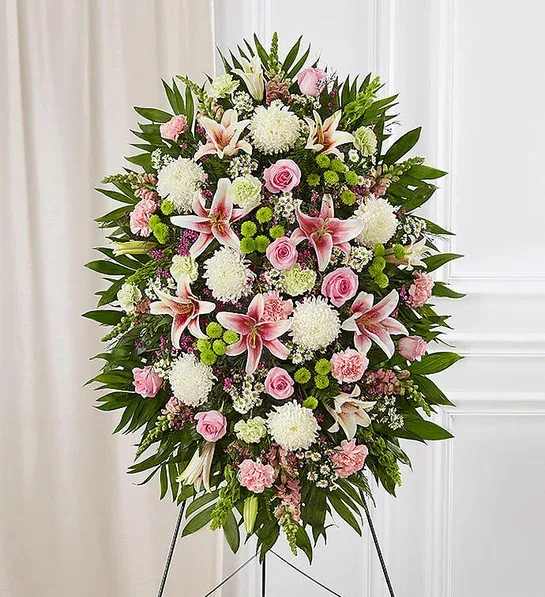 Standing floral spray with pink and white flowers on an easel