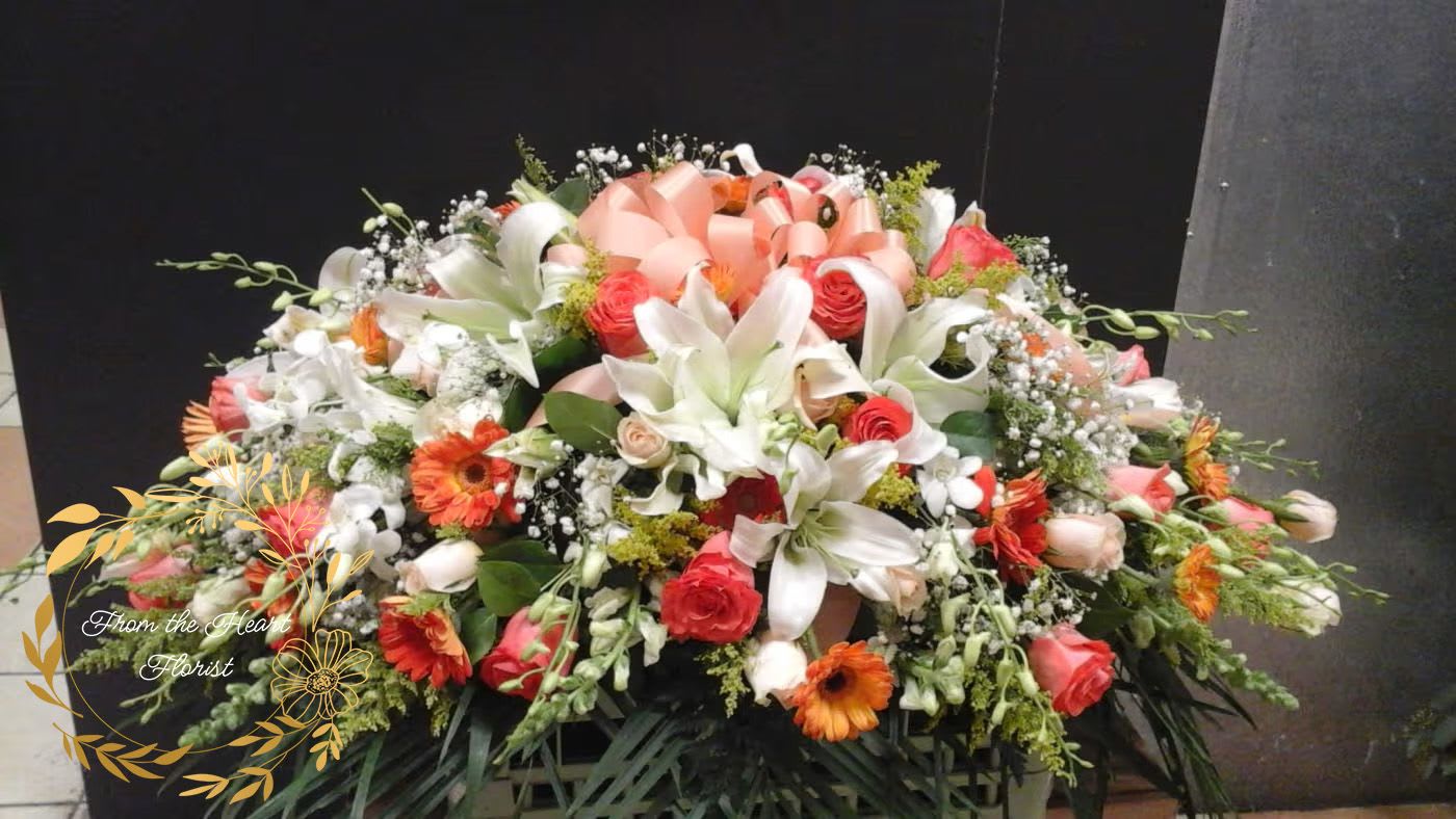 peach and white casket (FC2) - This casket spray make with white lilies , roses, snaps and  peach roses, gebera daisy . 