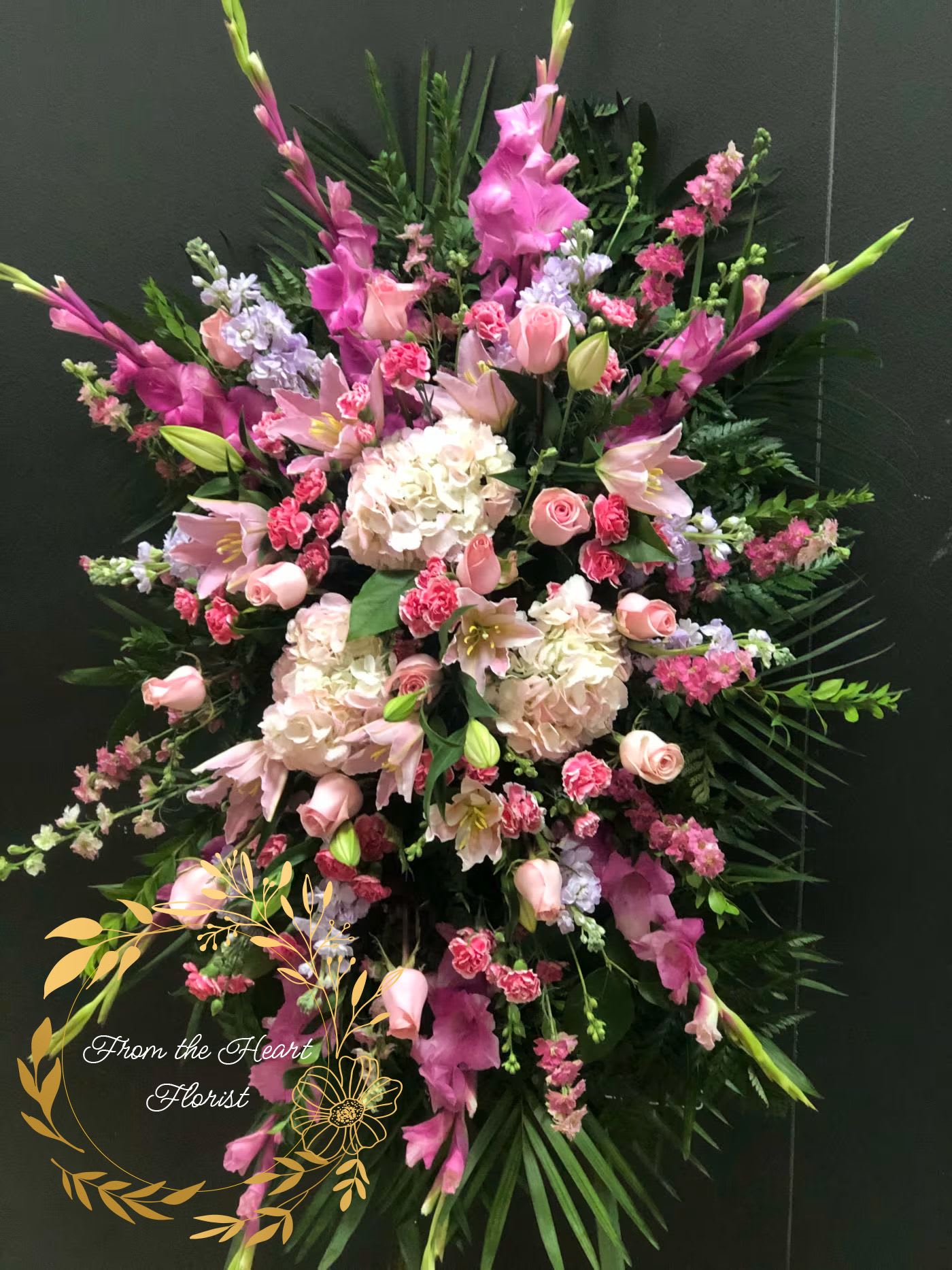 Large pink and white floral standing spray with lilies and roses