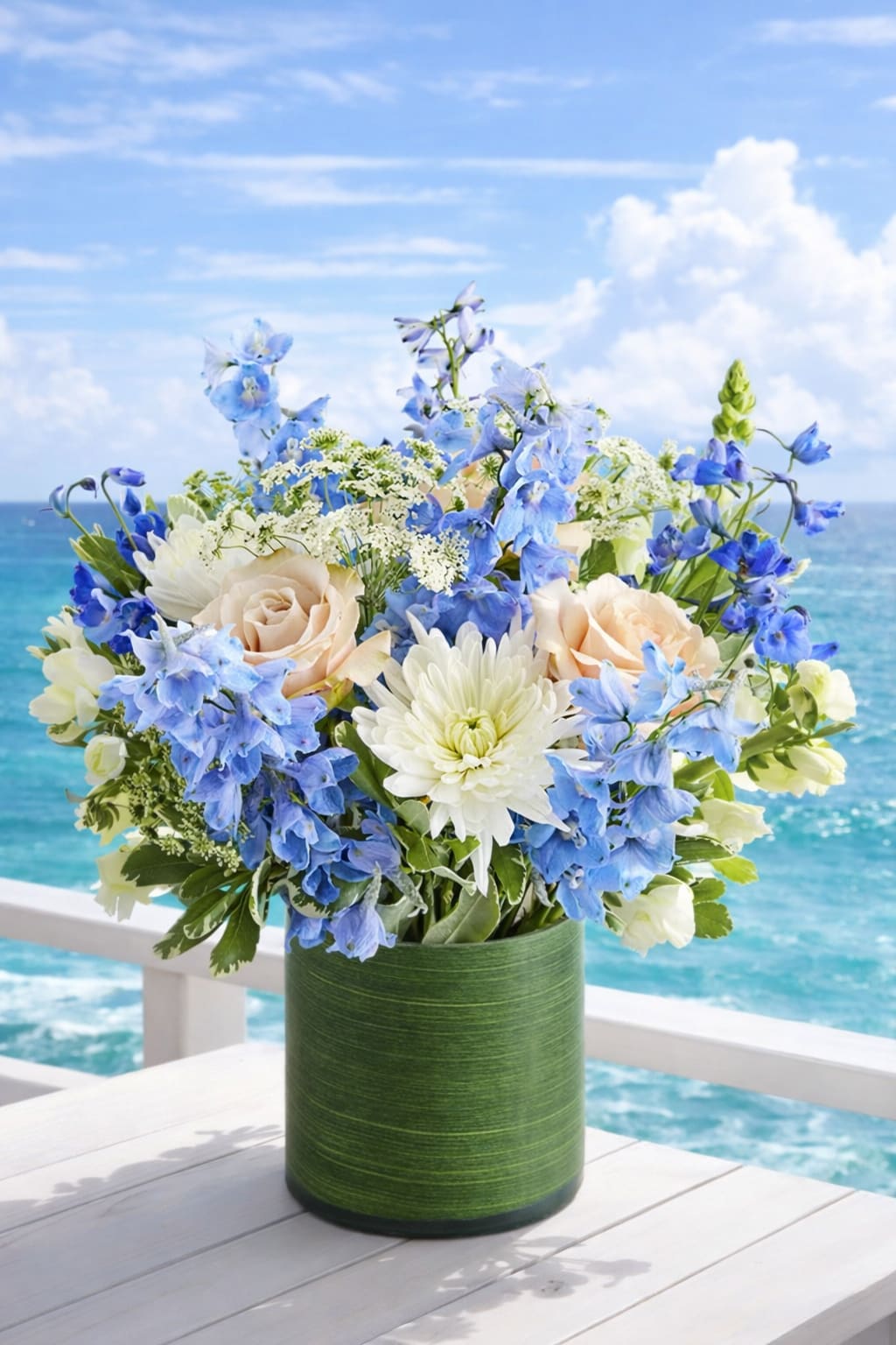 Ocean Breeze  - This beautiful ocean breeze arrangement made with pale roses, snapdragons, and other blooms complement the sunny delphiniums beautifully, making this bouquet a surefire way to brighten someone’s day.