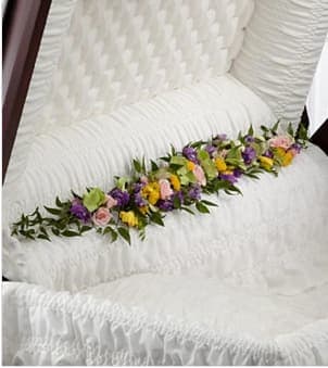 The FTD® Trail of Flowers™ Casket Adornment - The FTD® Trail of Flowers™ Casket Adornment is a gorgeous accent piece that offers an extra touch of floral beauty at their memorial service. Green hydrangea, pink spray roses, yellow freesia, lavender larkspur and yellow button poms are arranged to bedeck the inner lining of the casket creating a soft and elegant look that perfectly commemorates the life of the deceased. Approximately 40"W x 6"D. Your purchase includes a complimentary personalized gift message.