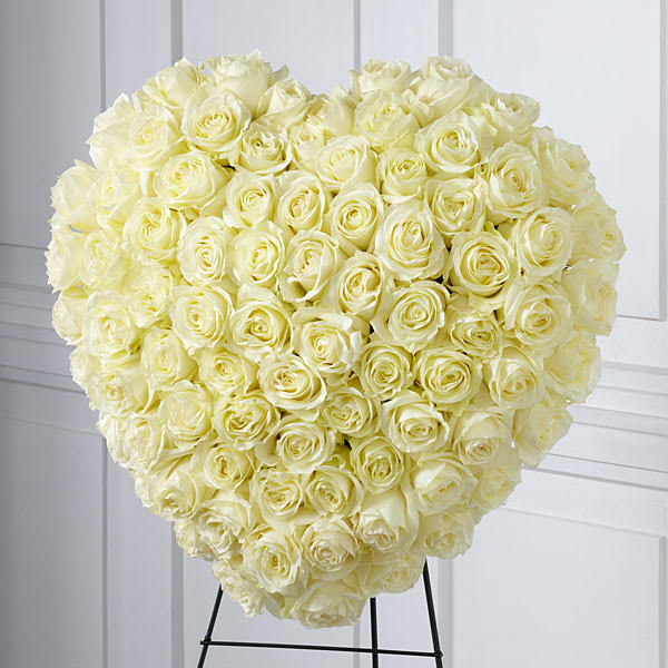 Heart-shaped bouquet of cream roses on a stand