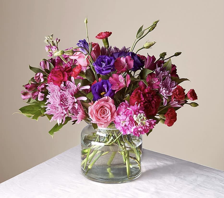 Mixed pink and purple bouquet in a clear glass vase