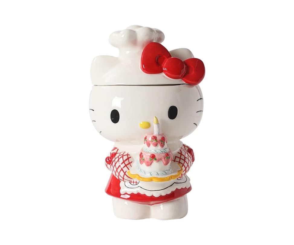 Hello Kitty figurine holding a birthday cake