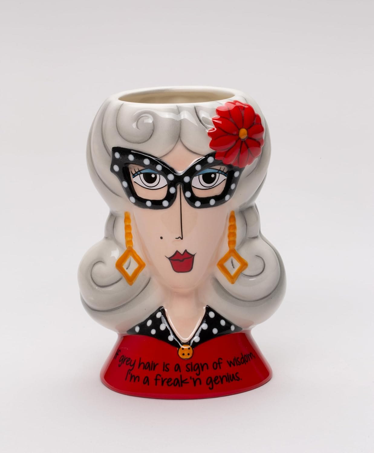Decorative ceramic planter shaped like a woman’s face with gray hair and a red flower
