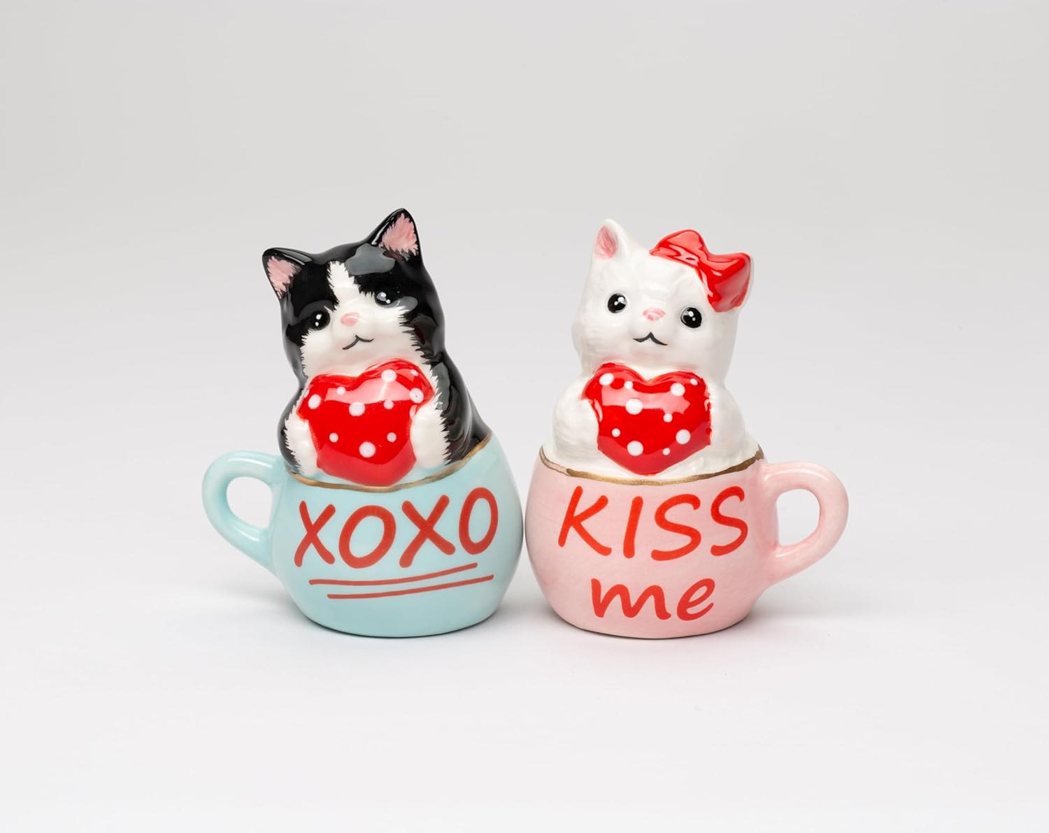 Two cat figurines in mugs with Valentine messages