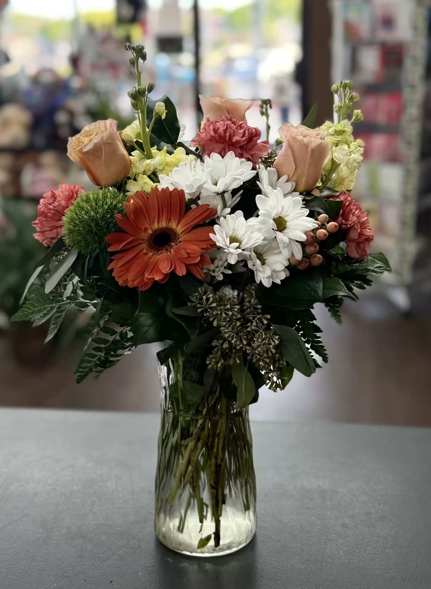 Petal Party - Mixed bouquet of roses, gerbera, carnations, stock and coffee berries in peach, yellow and orange hues  