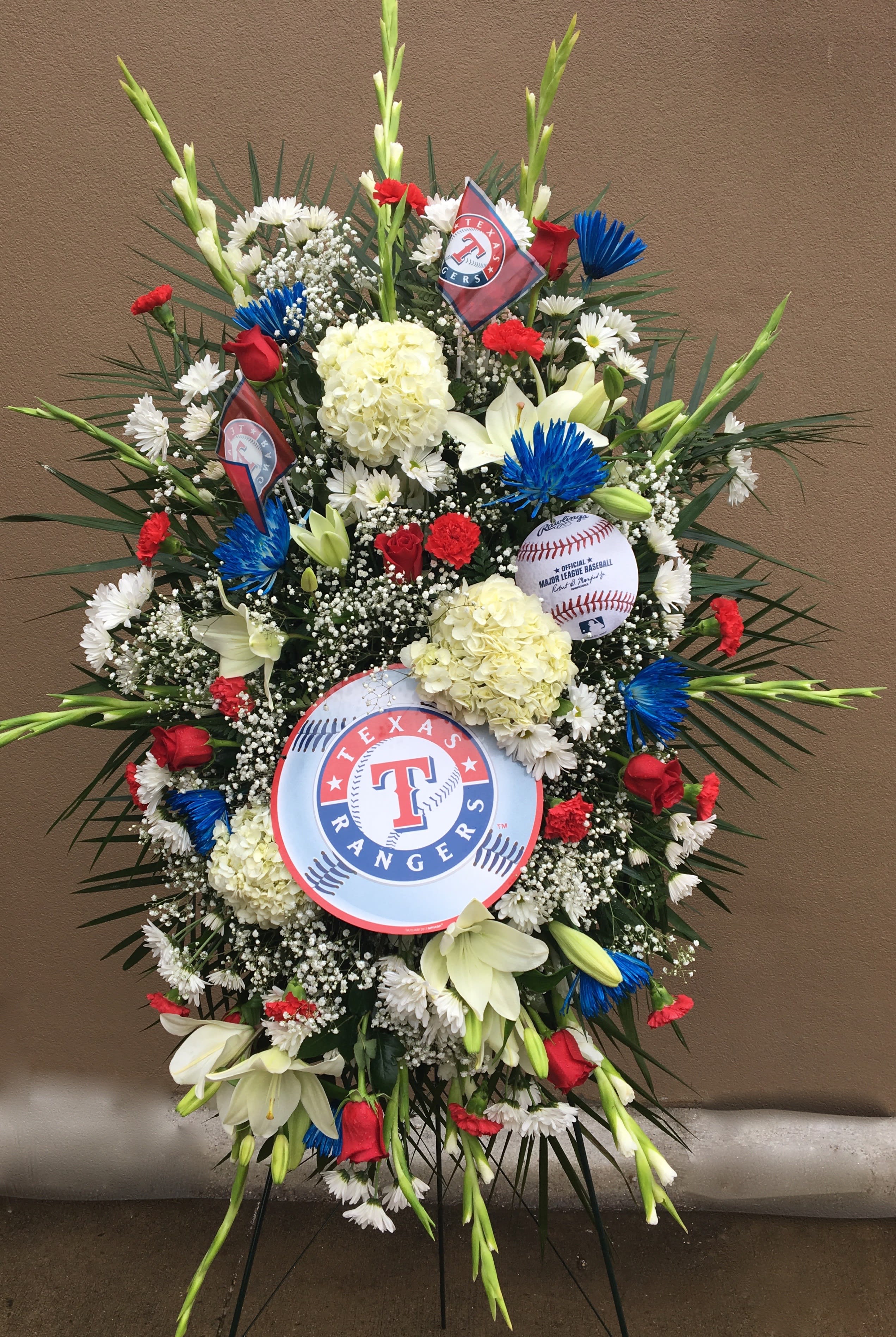 Large standing floral spray with Texas Rangers logos and baseball accents