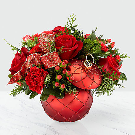 Red roses and carnations arranged in a red ornament-shaped container