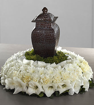 White floral wreath around a dark decorative lantern centerpiece