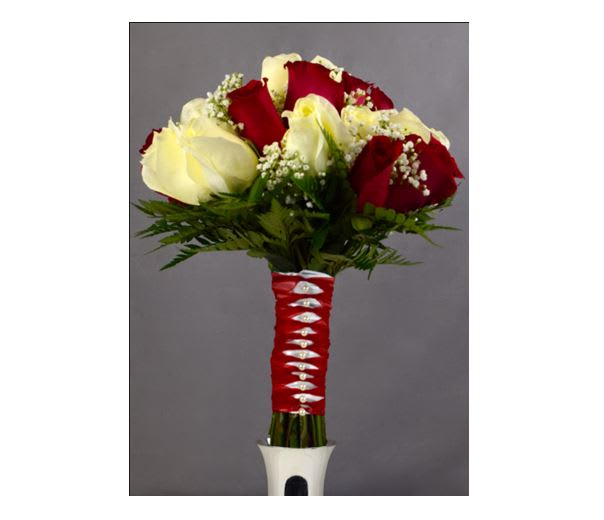 Bouquet of red and white roses with baby's breath in a wrapped handle