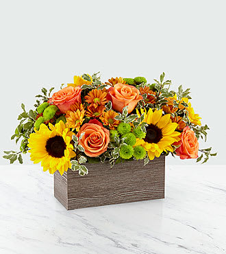 Sunflowers and orange roses in a rectangular wooden box