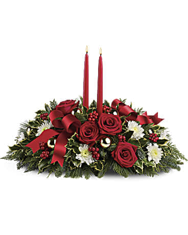 Red rose centerpiece with two red candles and holiday ribbon