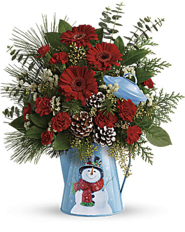 Red gerbera daisies and carnations in a blue snowman vase