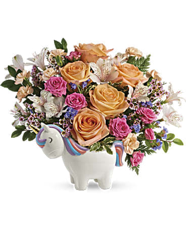 Bouquet of peach and pink roses in a unicorn-shaped vase