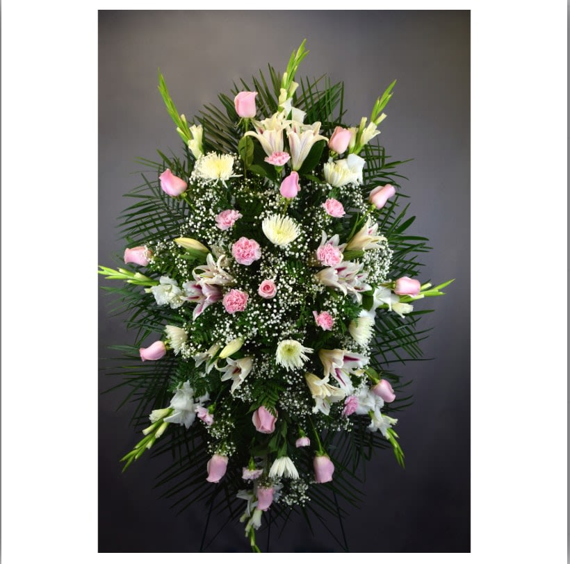 Tall standing floral spray with pink and white flowers on a dark background