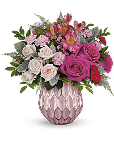Pink and white rose bouquet in a textured pink vase