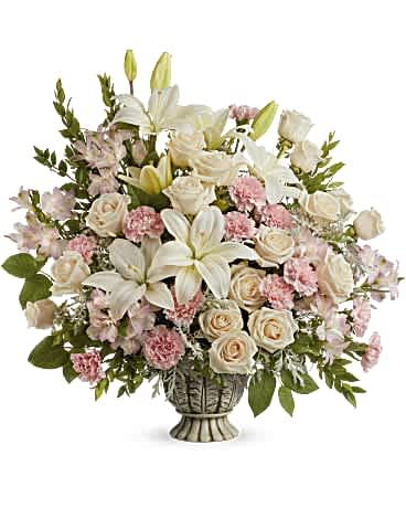 White lilies and pale roses in a decorative vase