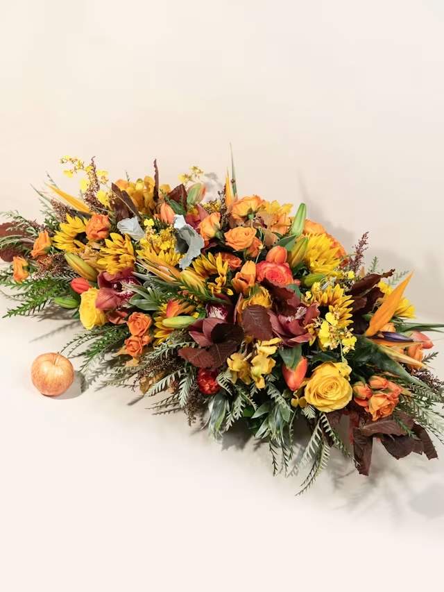 Autumn floral centerpiece with orange and yellow blooms